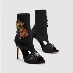 High heel sock-style sandals with flowers